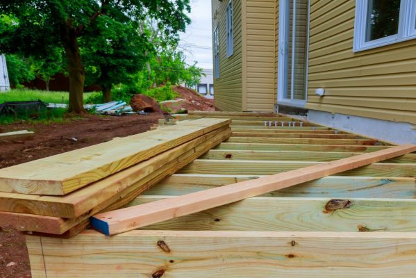 A installation wooden deck or patio new home, timber deck being constructed A installation wooden deck or patio new home, timber deck being constructed